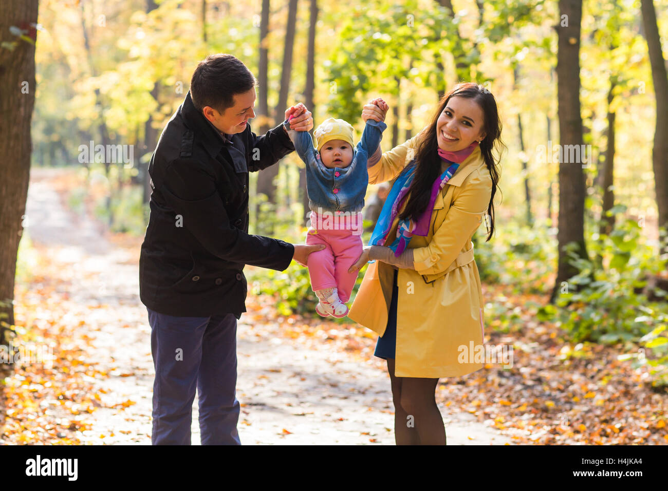 Happy family walking in the park in autumn together Stock Photo - Alamy