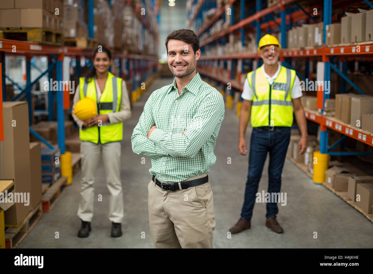 Portrait of warehouse team standing with arms crossed Stock Photo - Alamy