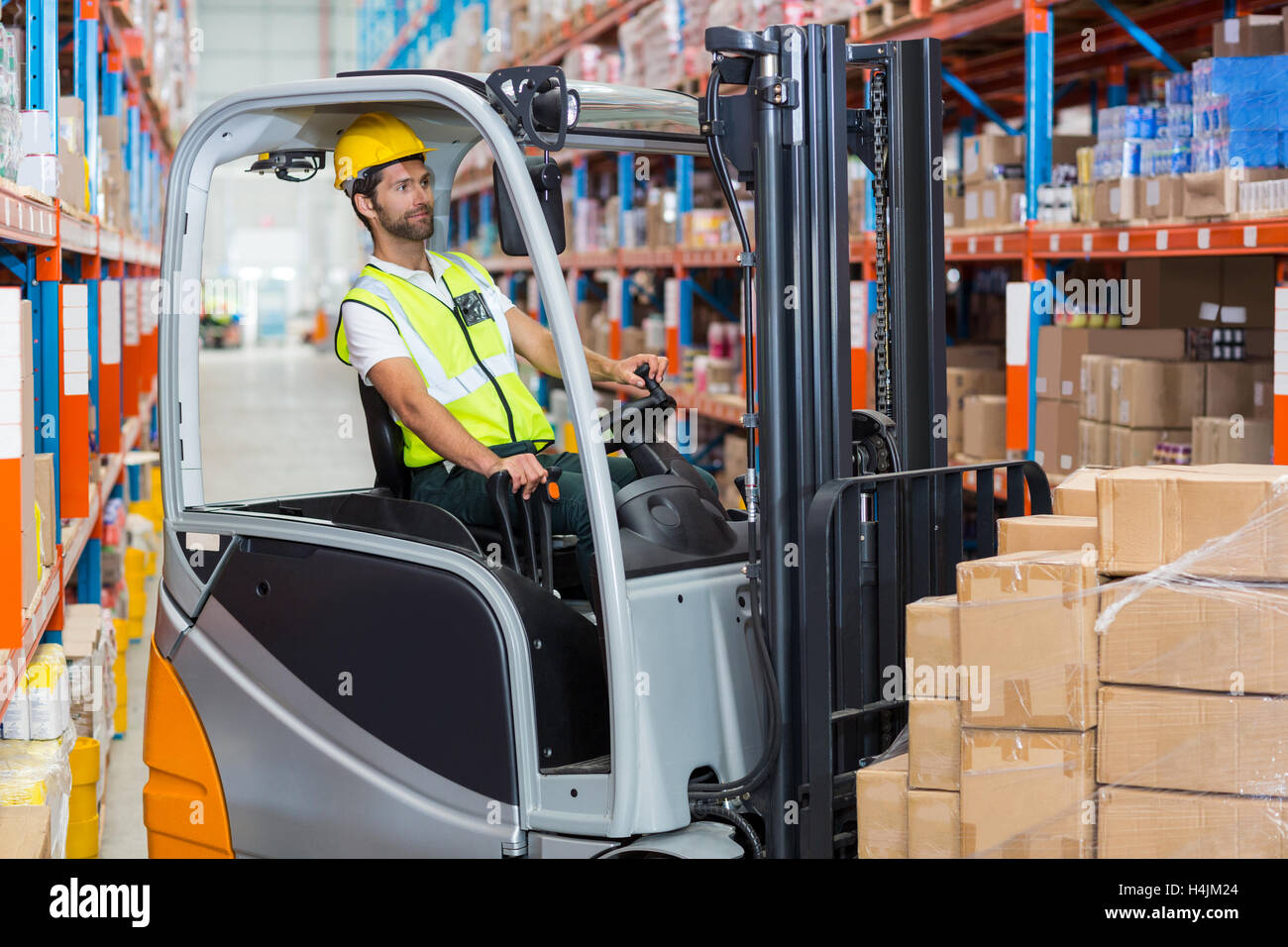 Male worker using forklift Stock Photo