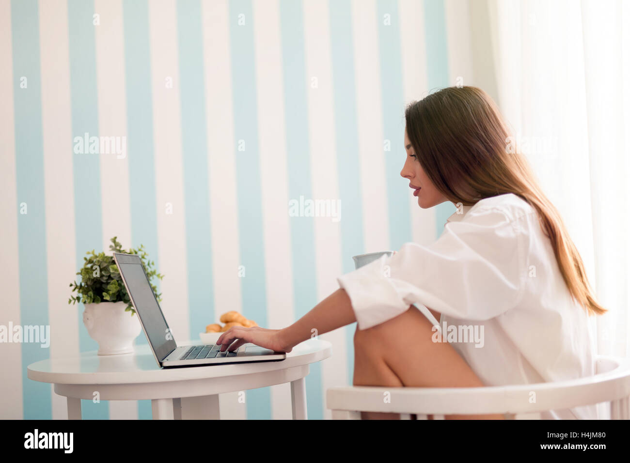 Beautiful woman reading news and drinking coffee Stock Photo