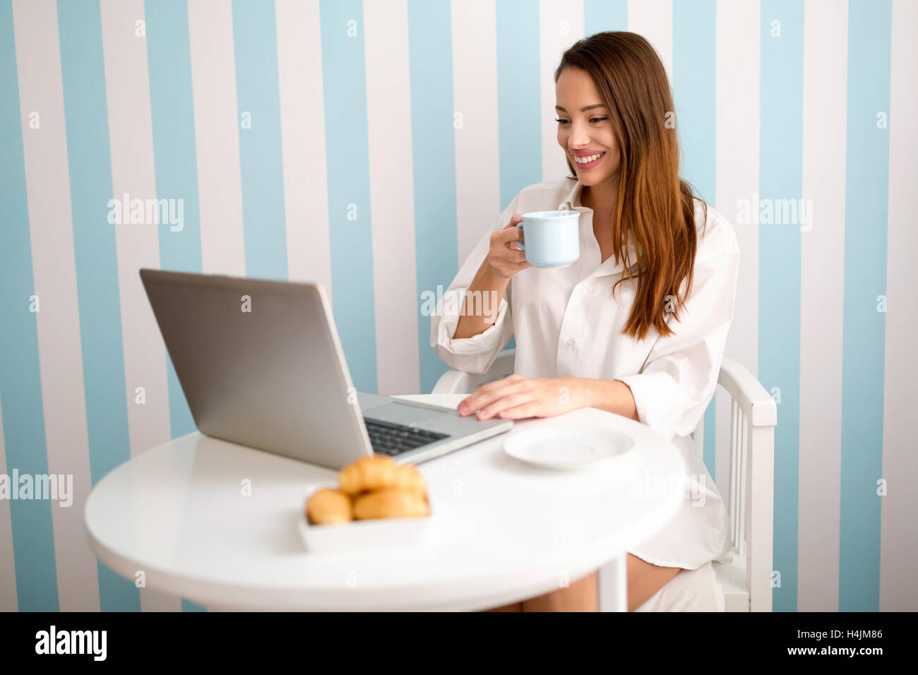 Beautiful woman reading news and drinking coffee Stock Photo