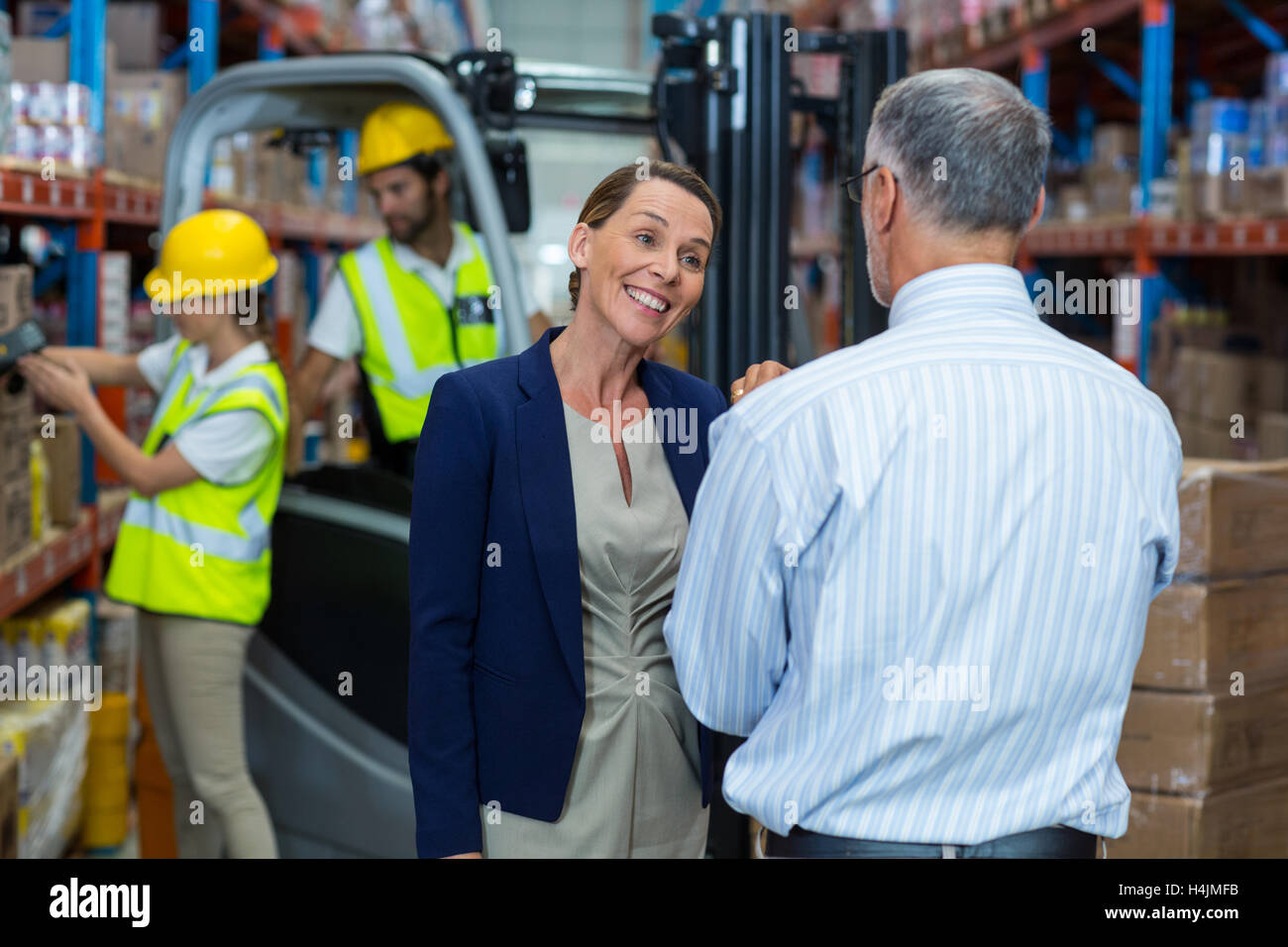 Warehouse manager and client interacting with each other Stock Photo