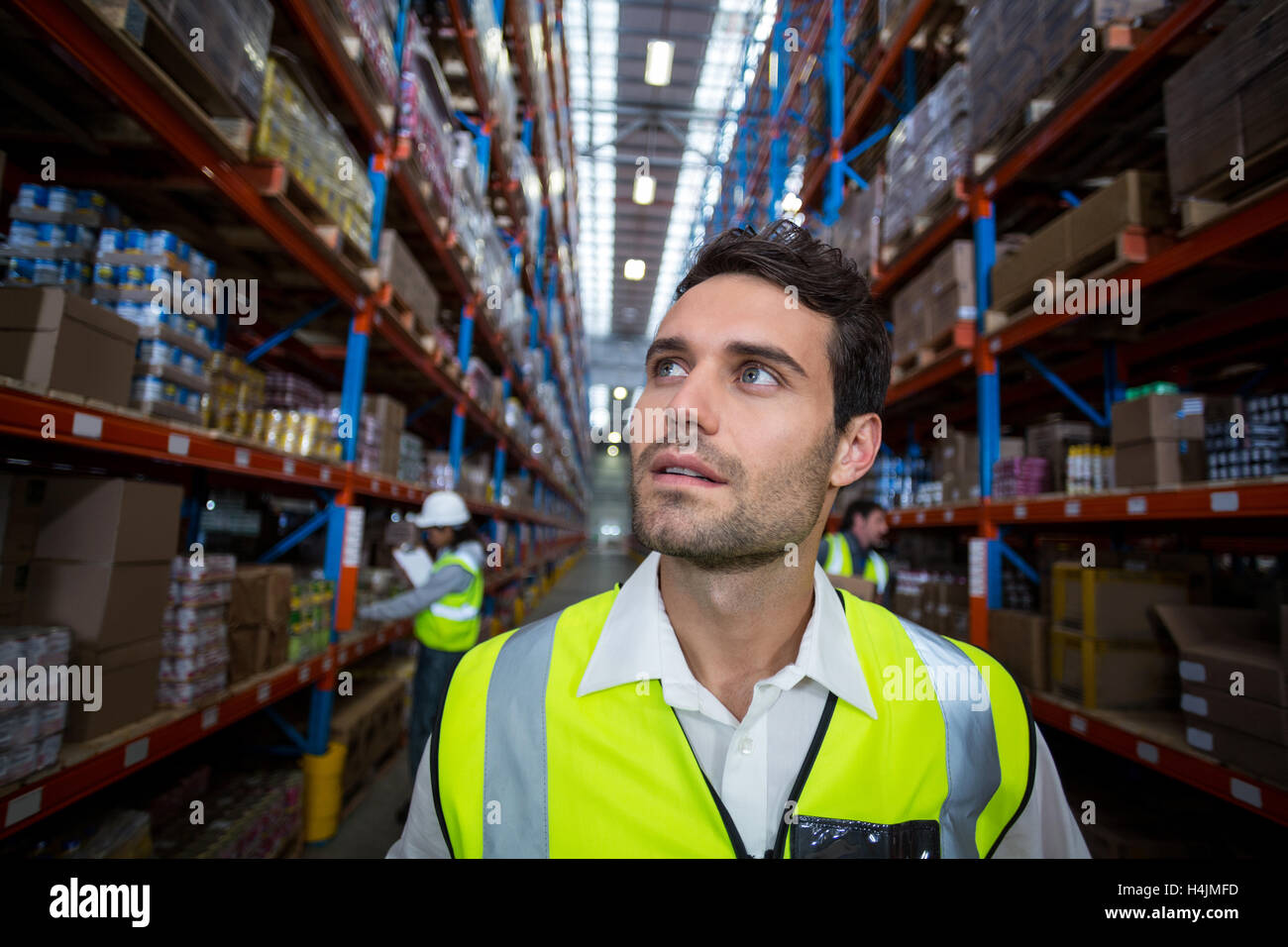 Warehouse worker looking at packages Stock Photo