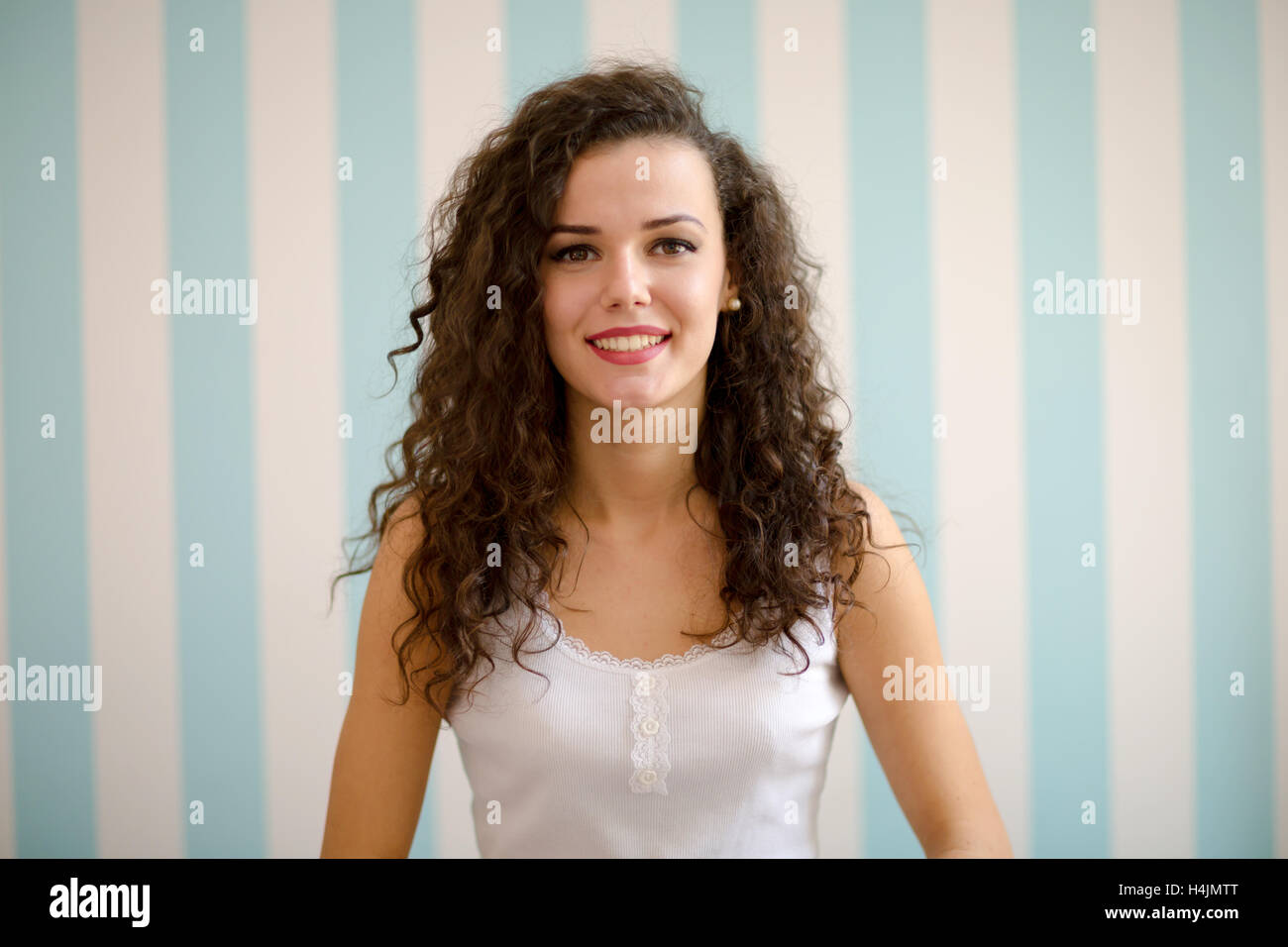 Portrait of a beautiful woman with curly hair smiling Stock Photo - Alamy