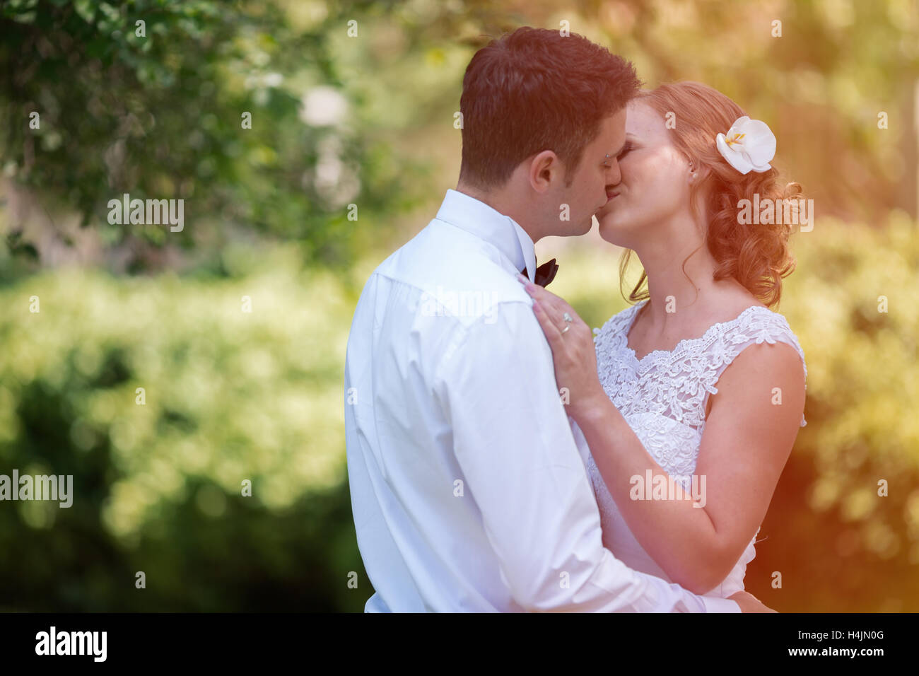 Beautiful bride and groom kissing outdoors after wedding Stock Photo ...