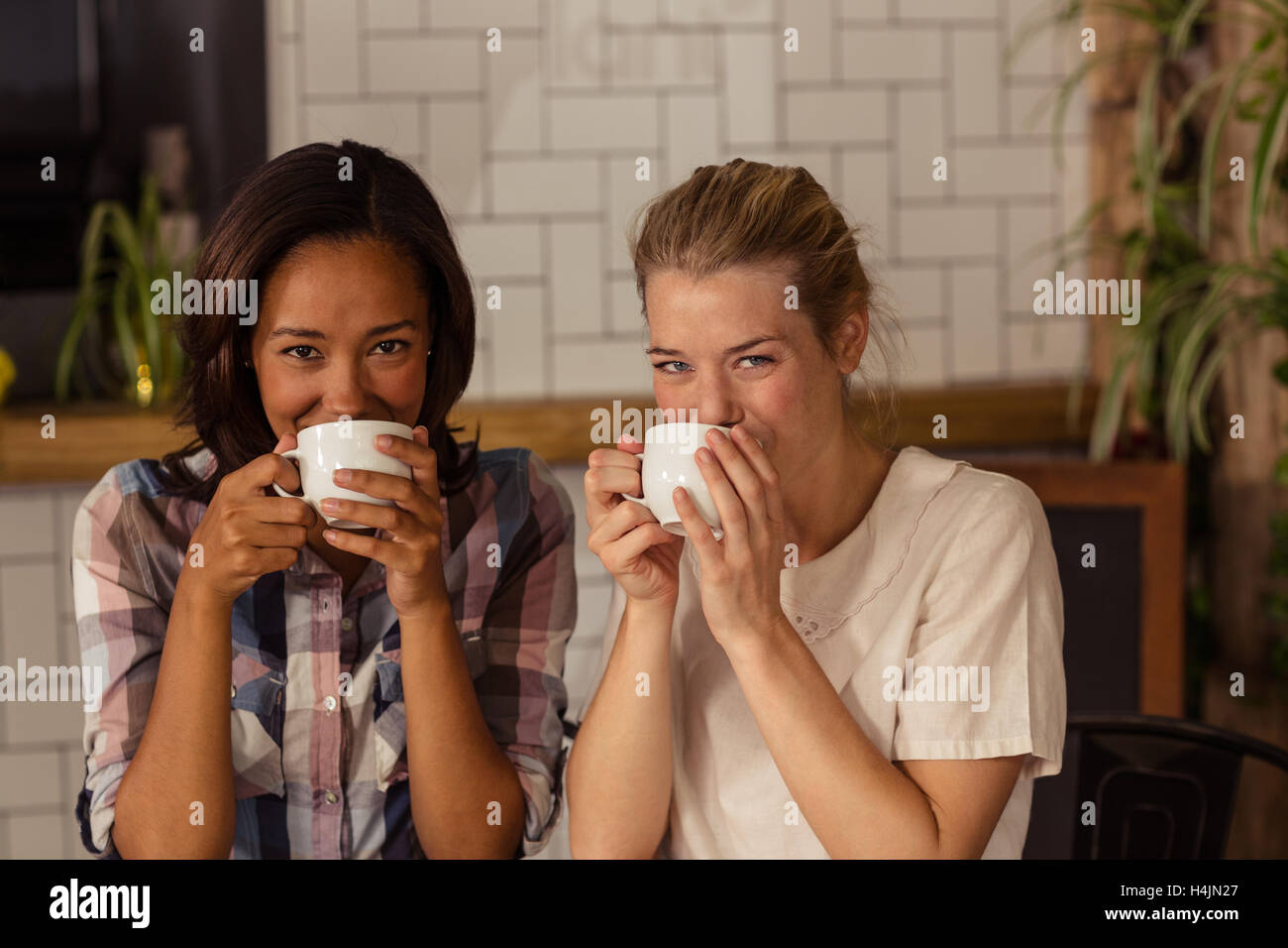 Portrait of female friends having coffee Stock Photo