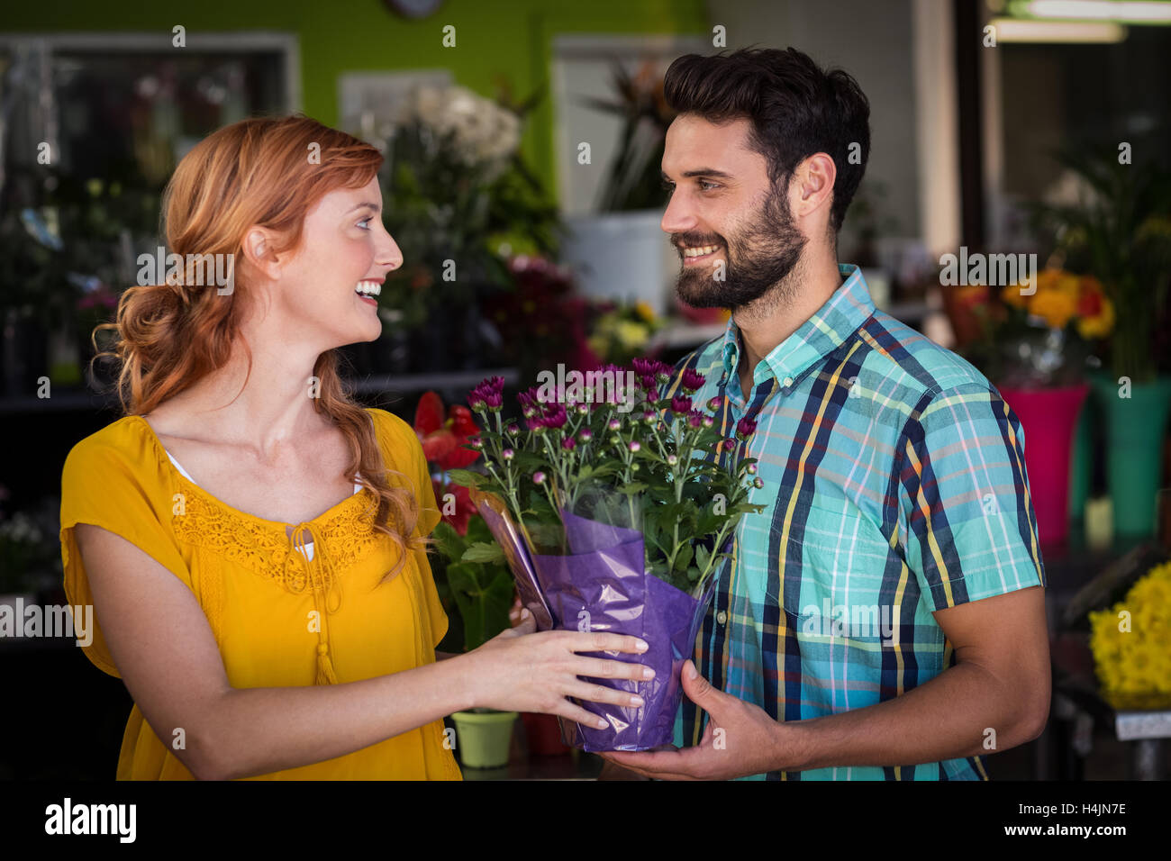 Female florist giving bouquet of flower to man Stock Photo Alamy