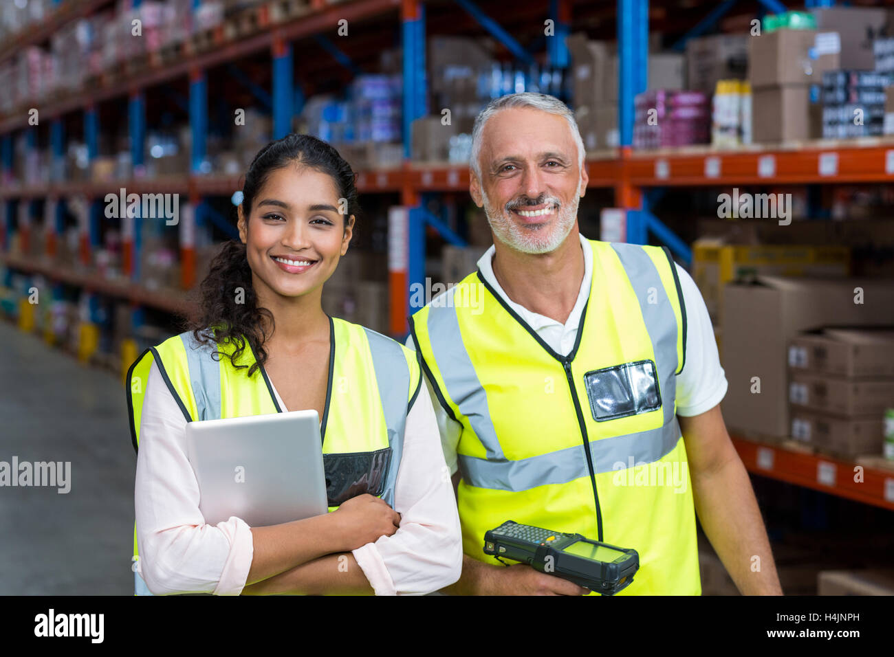 Portrait of warehouse workers standing with digital tablet and barcode scanner Stock Photo