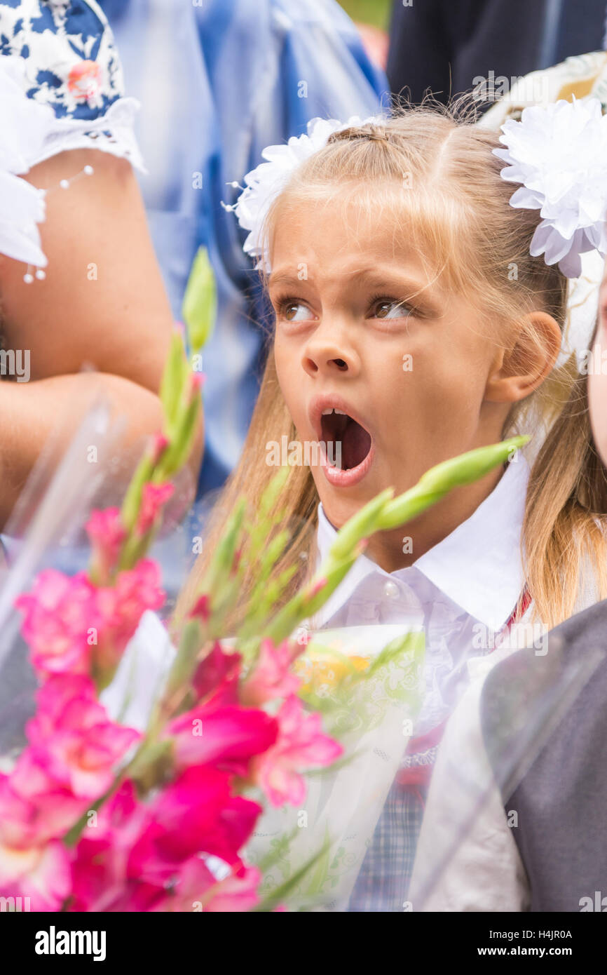 First grader yawning on line the first of September Stock Photo