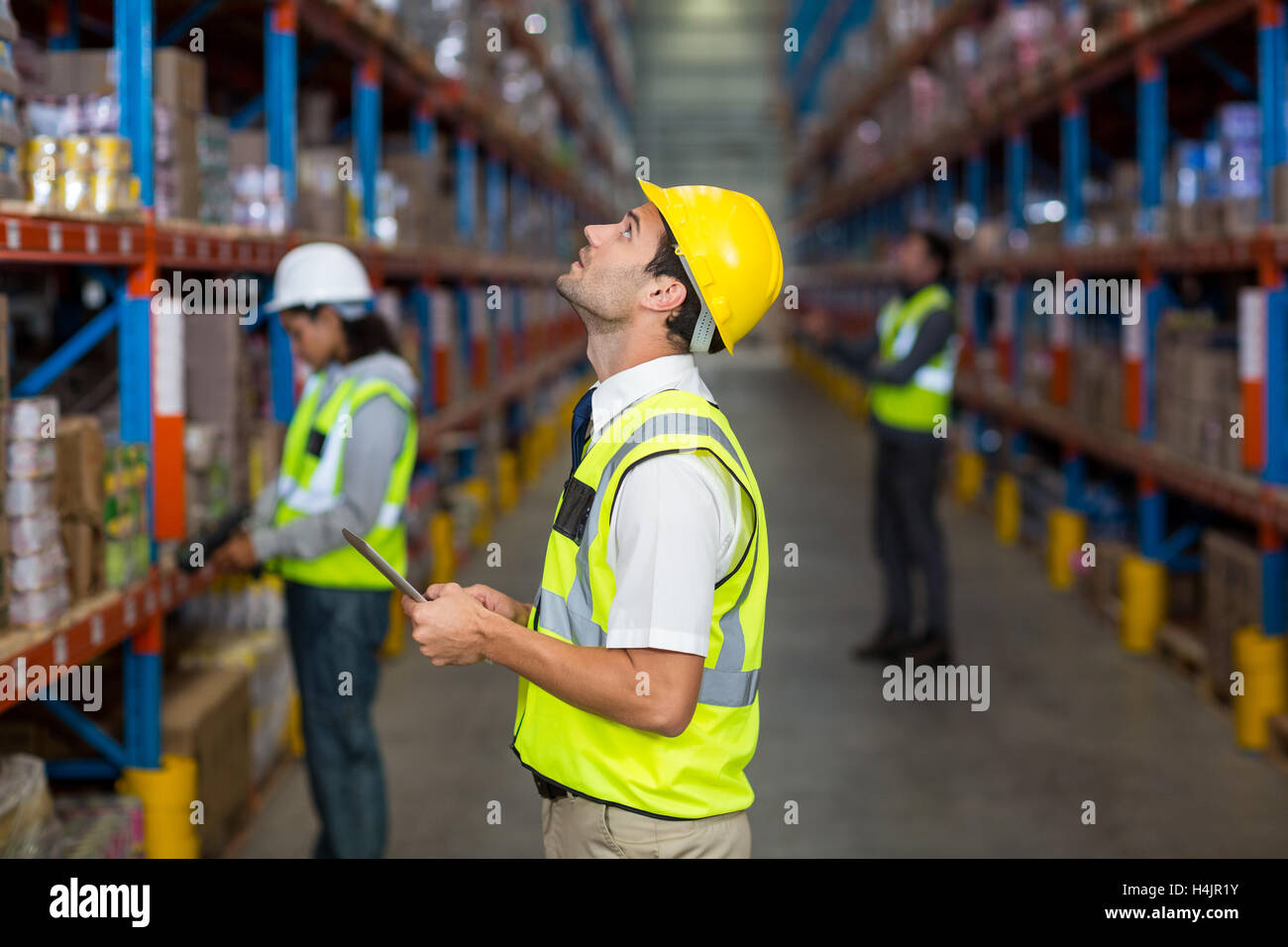 Warehouse manager looking at packages Stock Photo