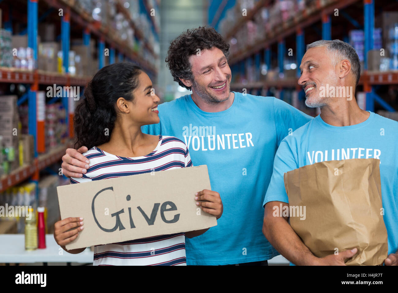 Happy colleagues holding sign boards with give message Stock Photo