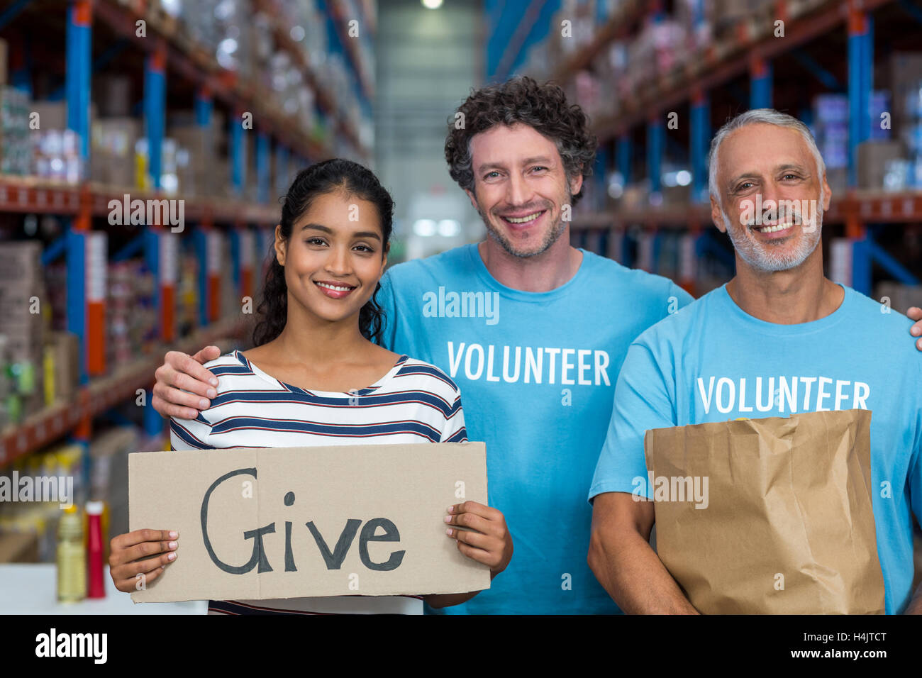 Happy colleagues holding sign boards with give message Stock Photo