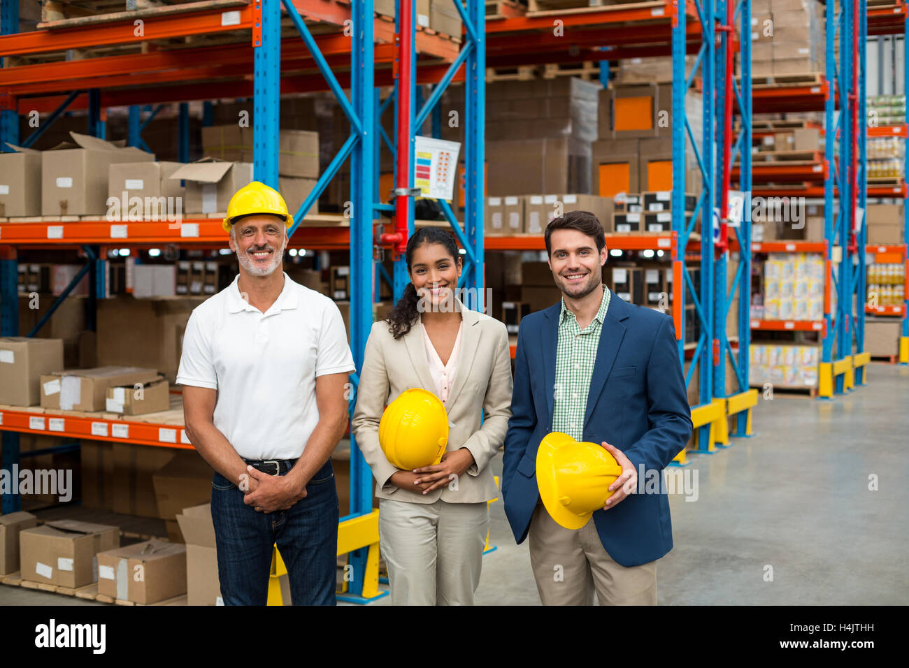 Portrait of warehouse managers and worker standing together Stock Photo ...