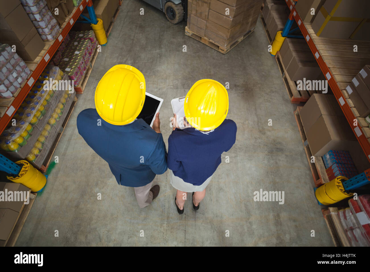 Warehouse manager and client standing Stock Photo