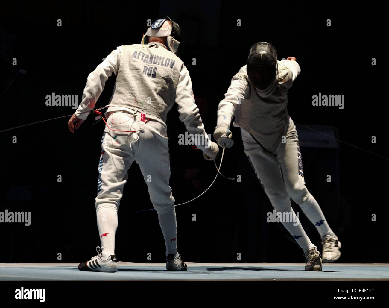 Stralsund, Germany. 13th Oct, 2016. Russian fencer Gari Aftandilov (l) in the final battle with Italy's Fabrizio Filippi at the Fencing World Championships of senior citizens in Stralsund, Germany, 13 October 2016. On the same day, Aftandilov became a world champion in the mens' cohort. Photo: Peter Endig/dpa - NO WIRE SERVICE-/dpa/Alamy Live News Stock Photo