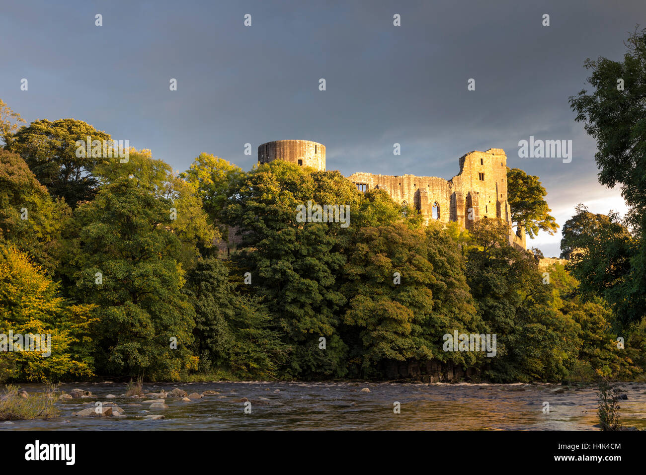 Barnard Castle, Teesdale, County Durham UK.  Monday 17th October 2016, UK Weather.  Golden light illuminating the medieval ruins of Barnard Castle this evening, after a day of sunshine and heavy showers.  After midnight heavy rain is expected to return and spread east, but should clear again by morning. Credit:  David Forster/Alamy Live News Stock Photo
