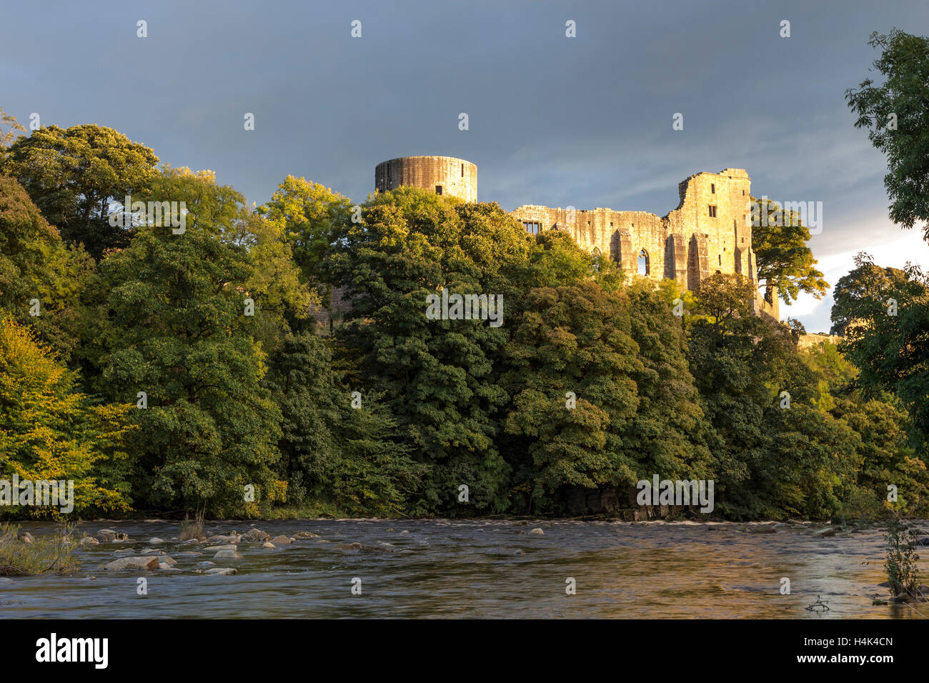 Barnard Castle, Teesdale, County Durham UK.  Monday 17th October 2016, UK Weather.  Golden light illuminating the medieval ruins of Barnard Castle this evening, after a day of sunshine and heavy showers.  After midnight heavy rain is expected to return and spread east, but should clear again by morning. Credit:  David Forster/Alamy Live News Stock Photo
