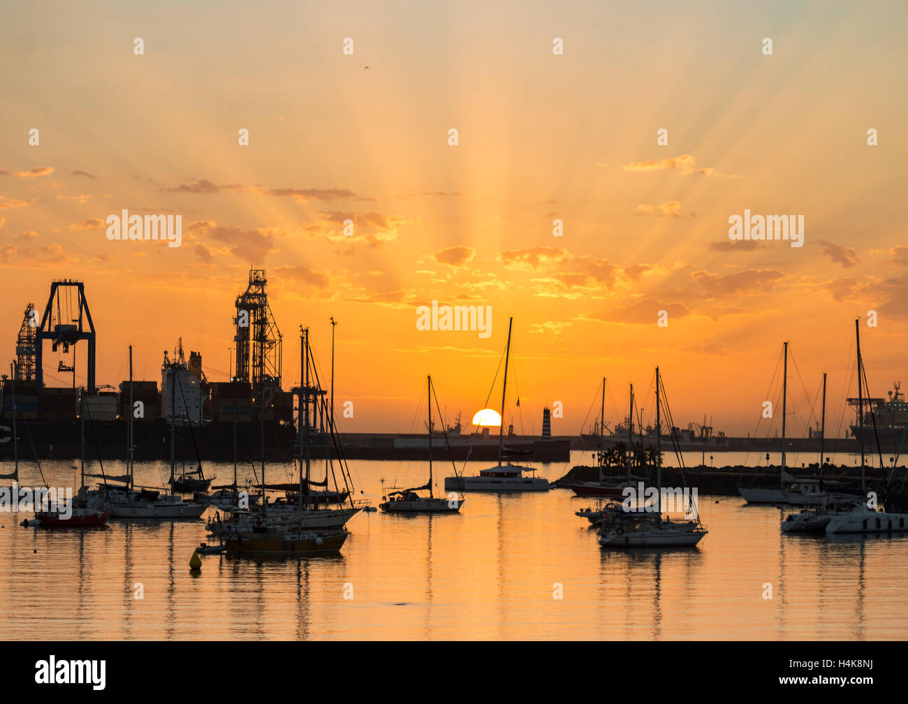 Las Palmas, Gran Canaria, Canary Islands, Spain. 18th Oct, 2016. Weather: A glorious sunrise on Gran Canaria as yachts start arriving for the ARC ( Atlantic Rally for Cruisers) transatlantic rally/crossing which starts in Las Palmas (in November) and finishes in Rodney Bay on Santa Lucia in The Caribbean. Crews from more than 40 different countries, including many from Great Britain, will be on board the 200 yachts to start the world`s largest transocean sailing event, now in its 31st year. Credit:  Alan Dawson News/Alamy Live News Stock Photo