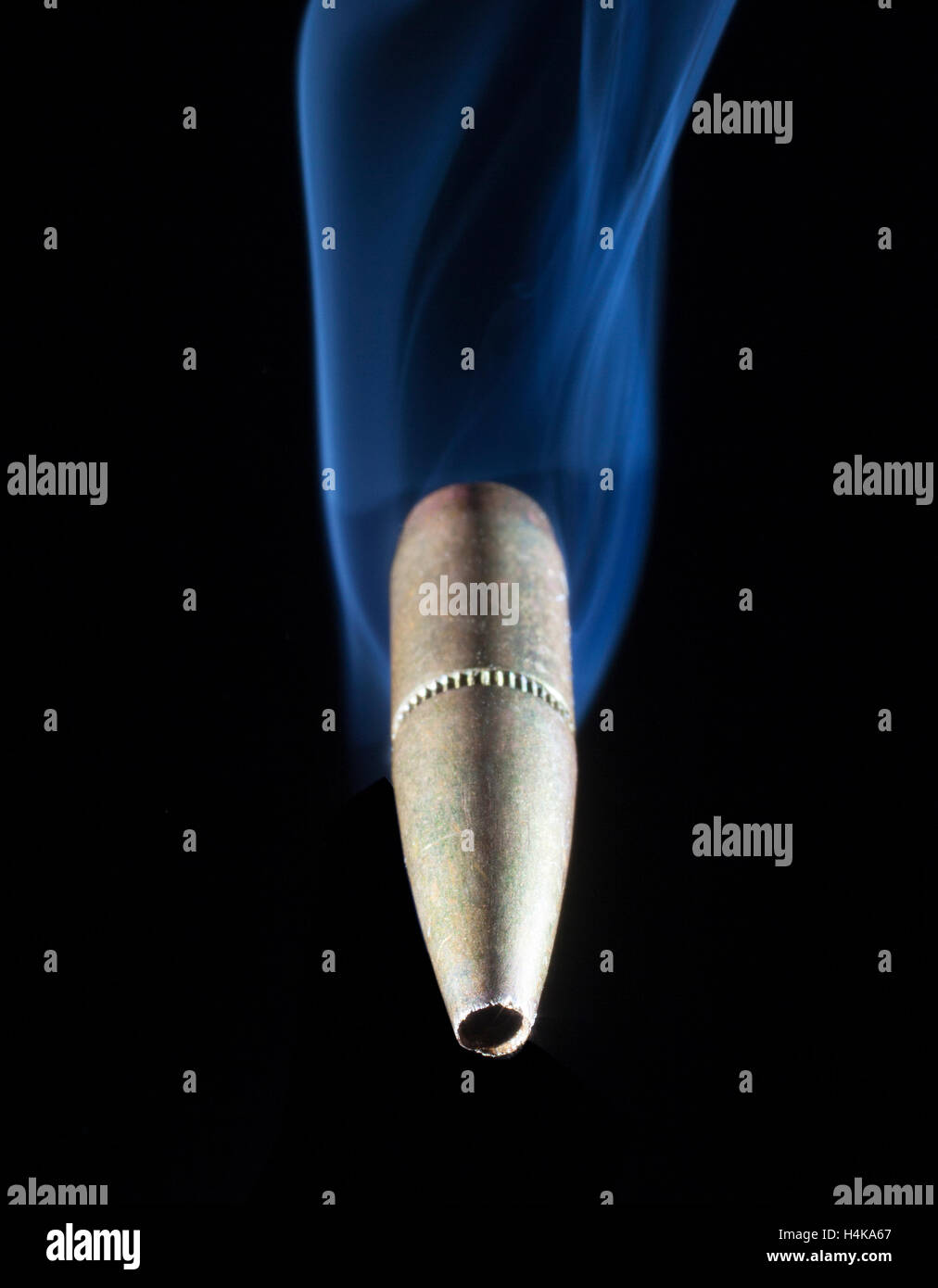 Single copper bullet that appears to be coming at the camera Stock