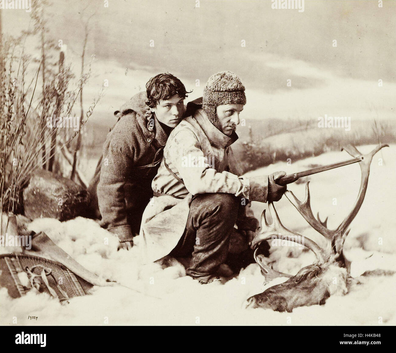 Two hunters in the snow in front of them a moose head, William Notman, 1866 Stock Photo