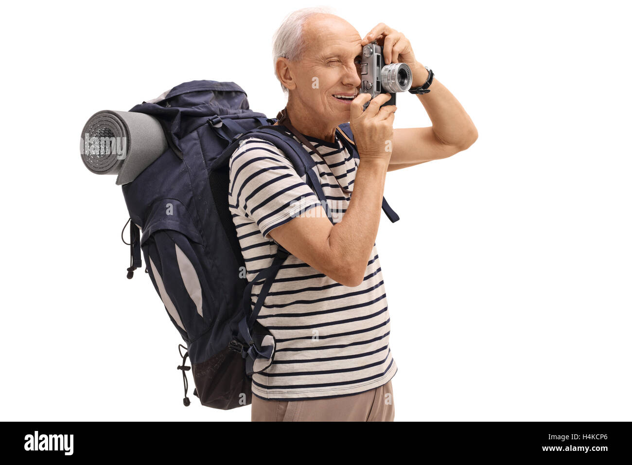 Elderly male hiker taking a picture with a camera isolated on white background Stock Photo