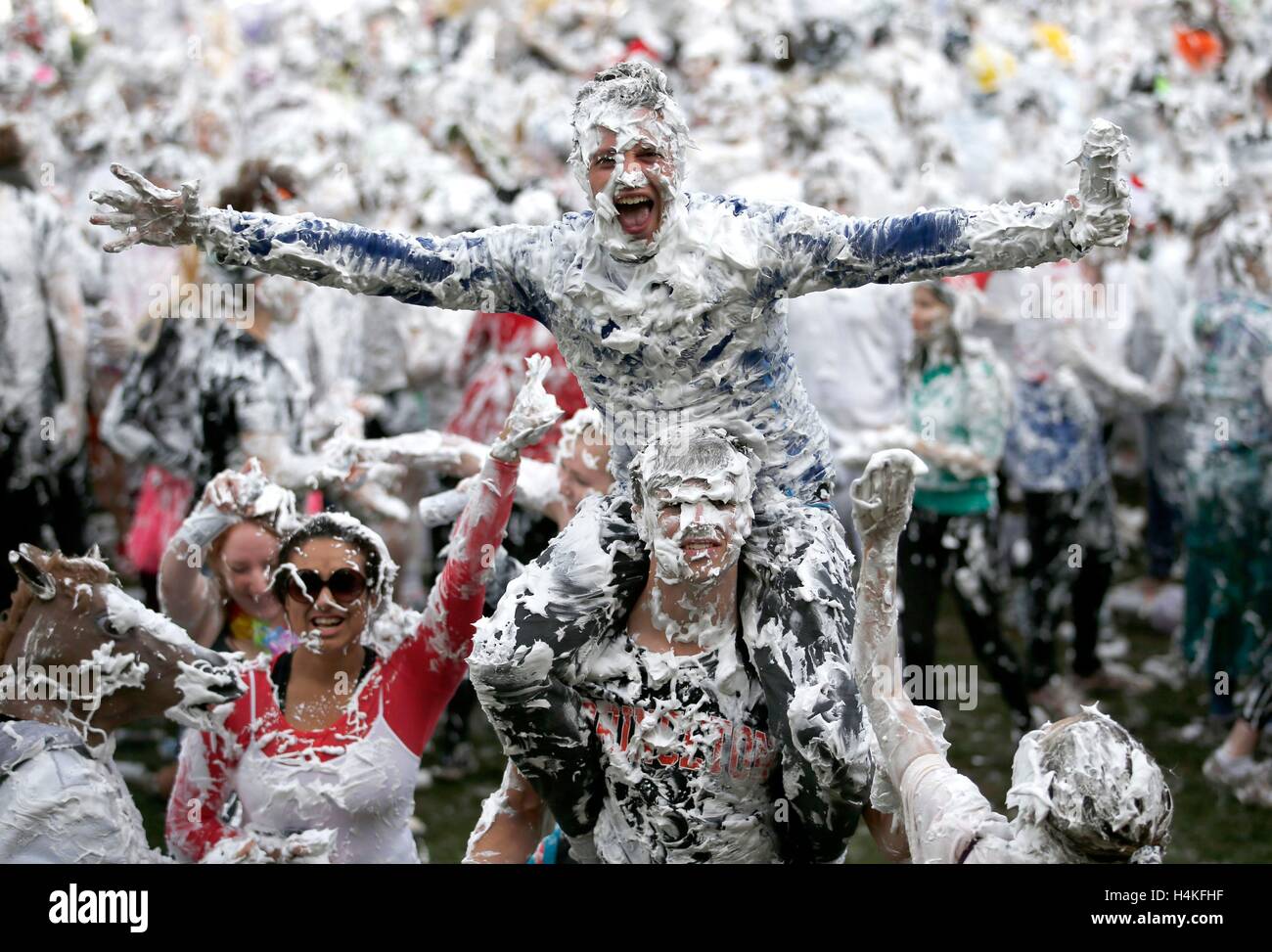 St Andrews University students take part in a foam fight known as Raisin Monday in the Lower College Lawn behind St Salvator's Quadrangle following the Raisin Weekend, an annual tradition where student 'parents' inflict tasks on the unfortunate first-years they have adopted as 'children' as part of a mentoring scheme. Stock Photo