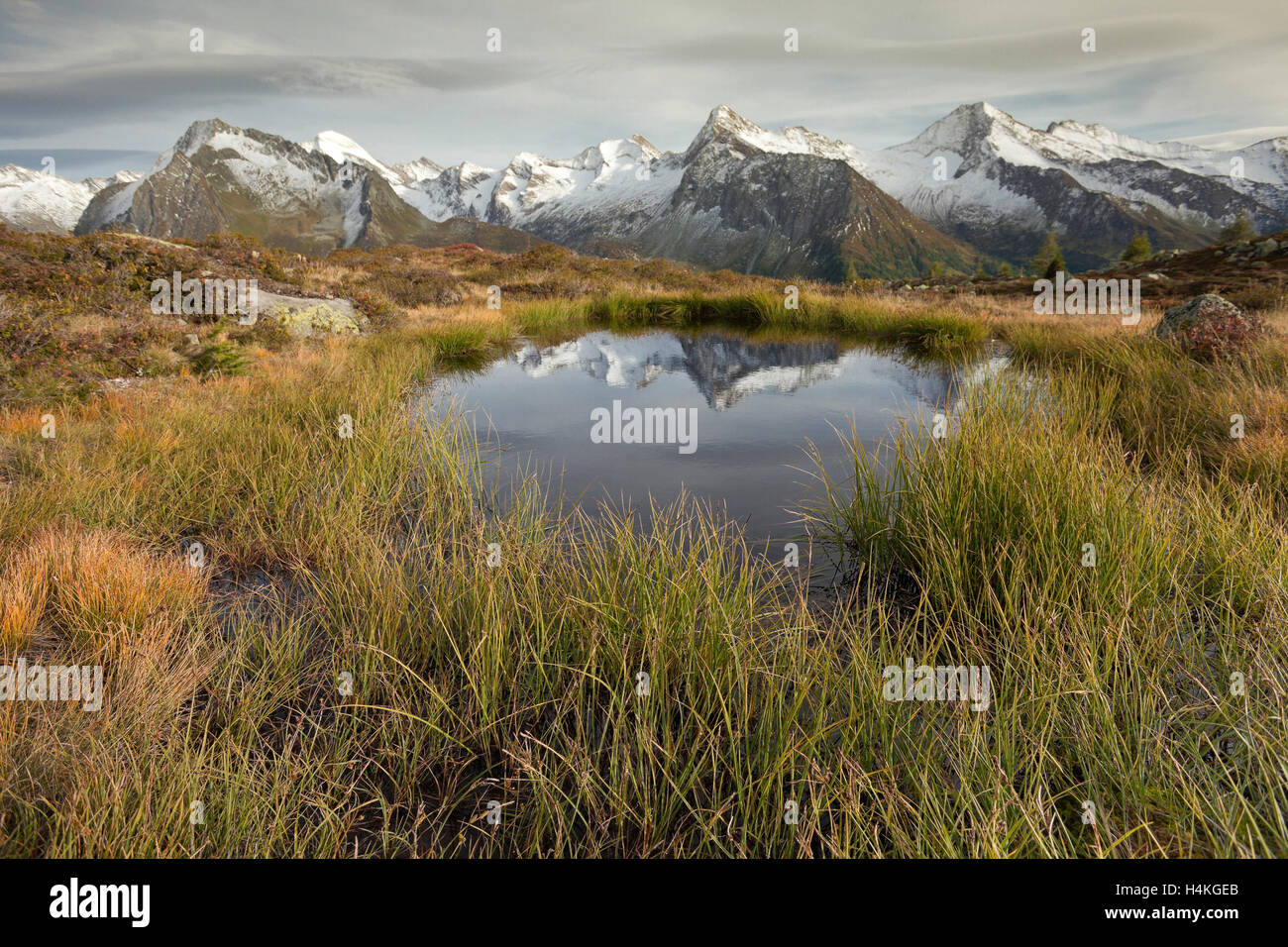 Alpine reflection: a small alpine lake in the Italian Alps; it's late ...