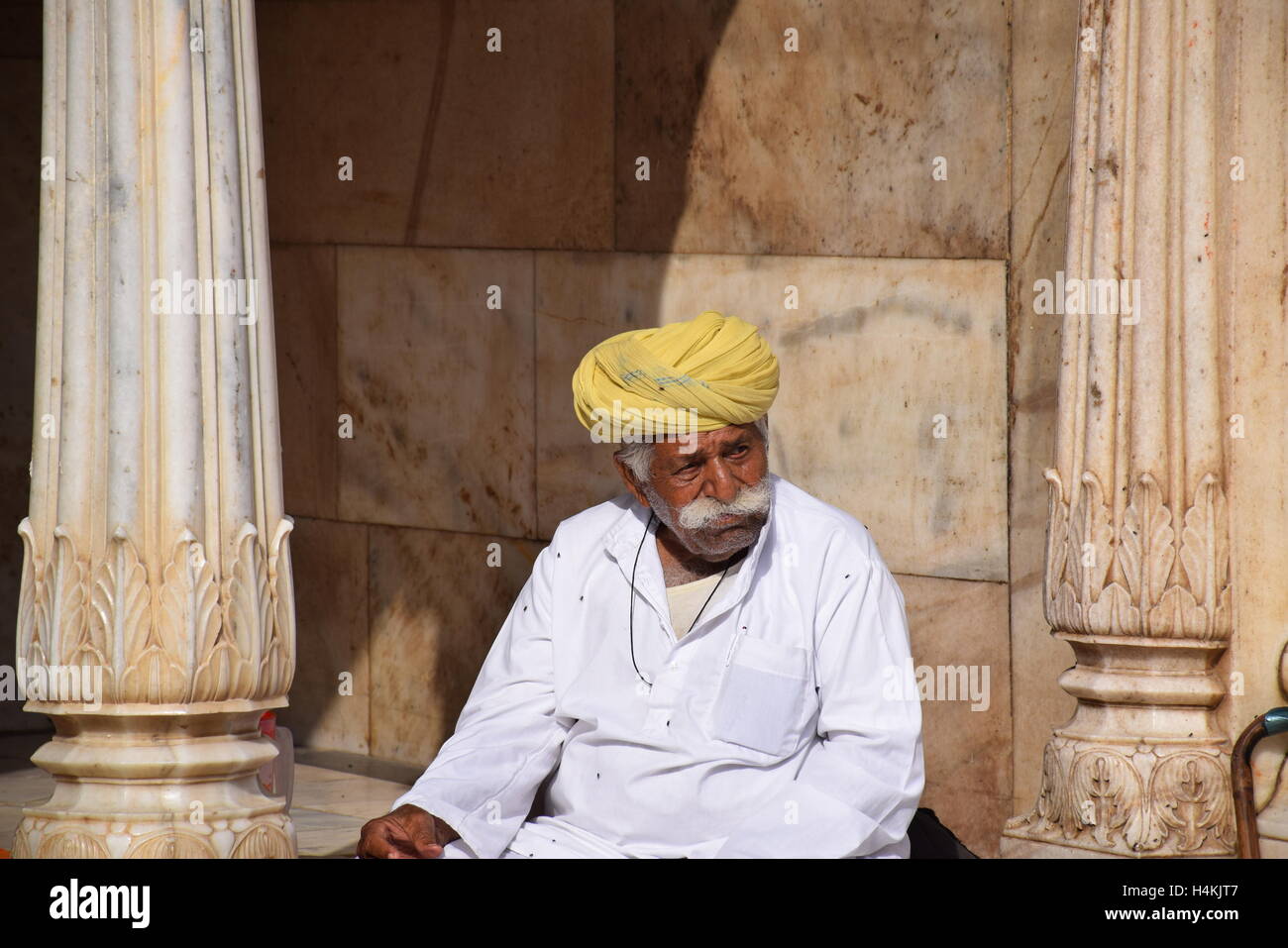Indian man sitting outside Karni Mata rat temple, Bikaner, Rajasthan, India Stock Photo
