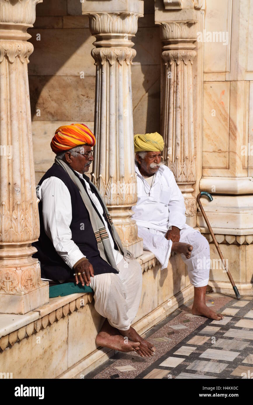 Two indian men sitting outside Karni Mata rat temple in Deshnoke (Bikaner), Rajasthan, India Stock Photo