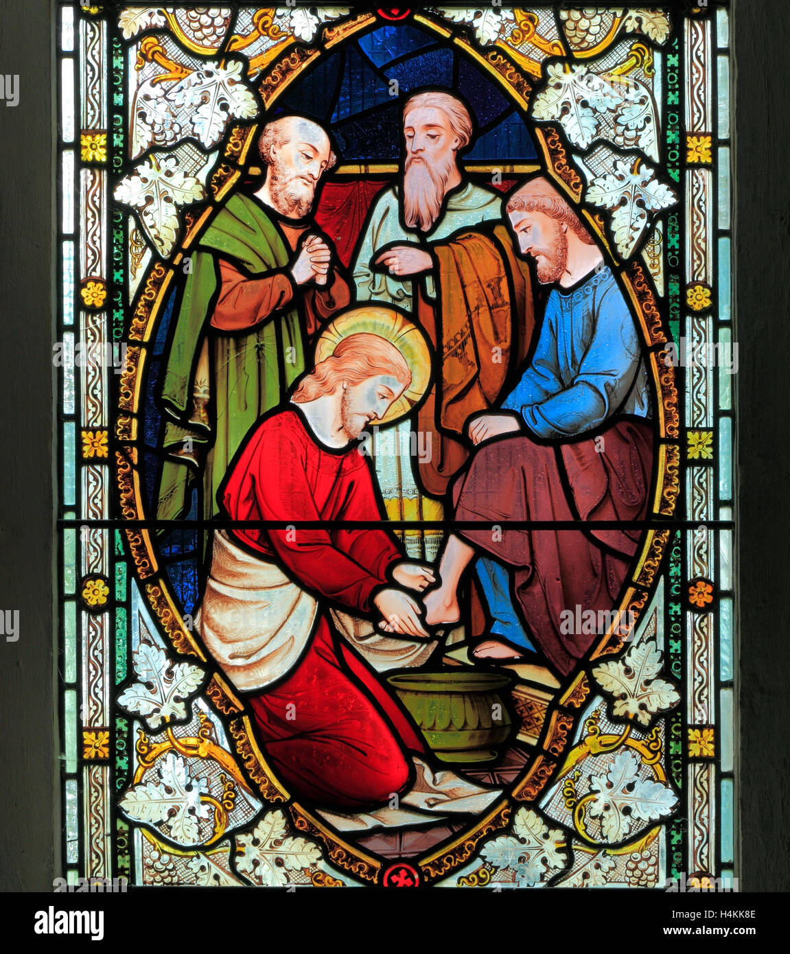 Jesus washing the feet of his Disciples, by Ward  & Hughes, 1869, stained glass window, Stanhoe, Norfolk England UK Stock Photo