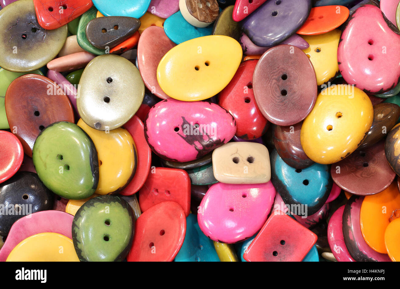 background of colorful buttons made with palm seeds for sale Stock