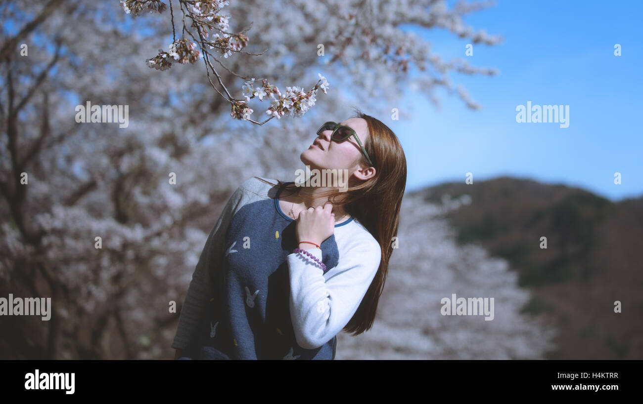 beautiful young woman in blooming cherry blossoms garden Stock Photo ...