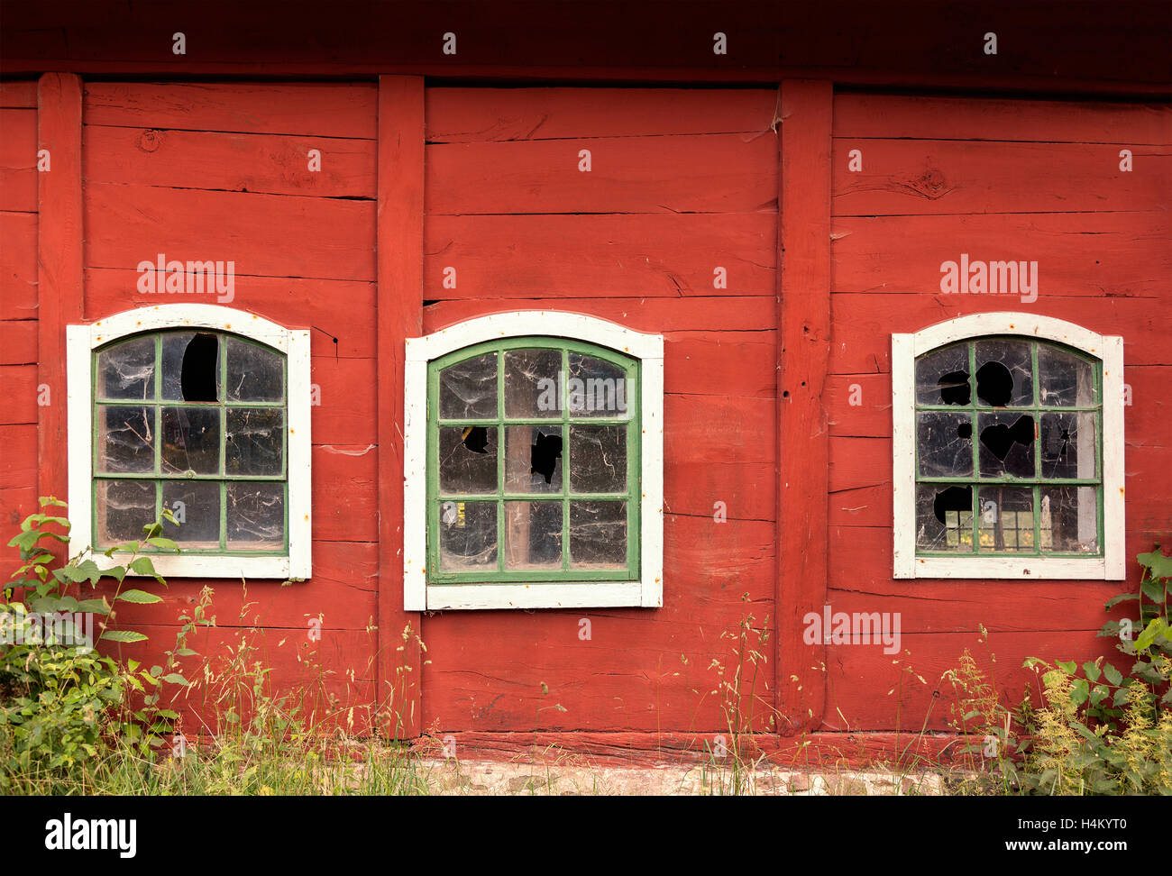 Image of broken windows on old farm building. Stock Photo