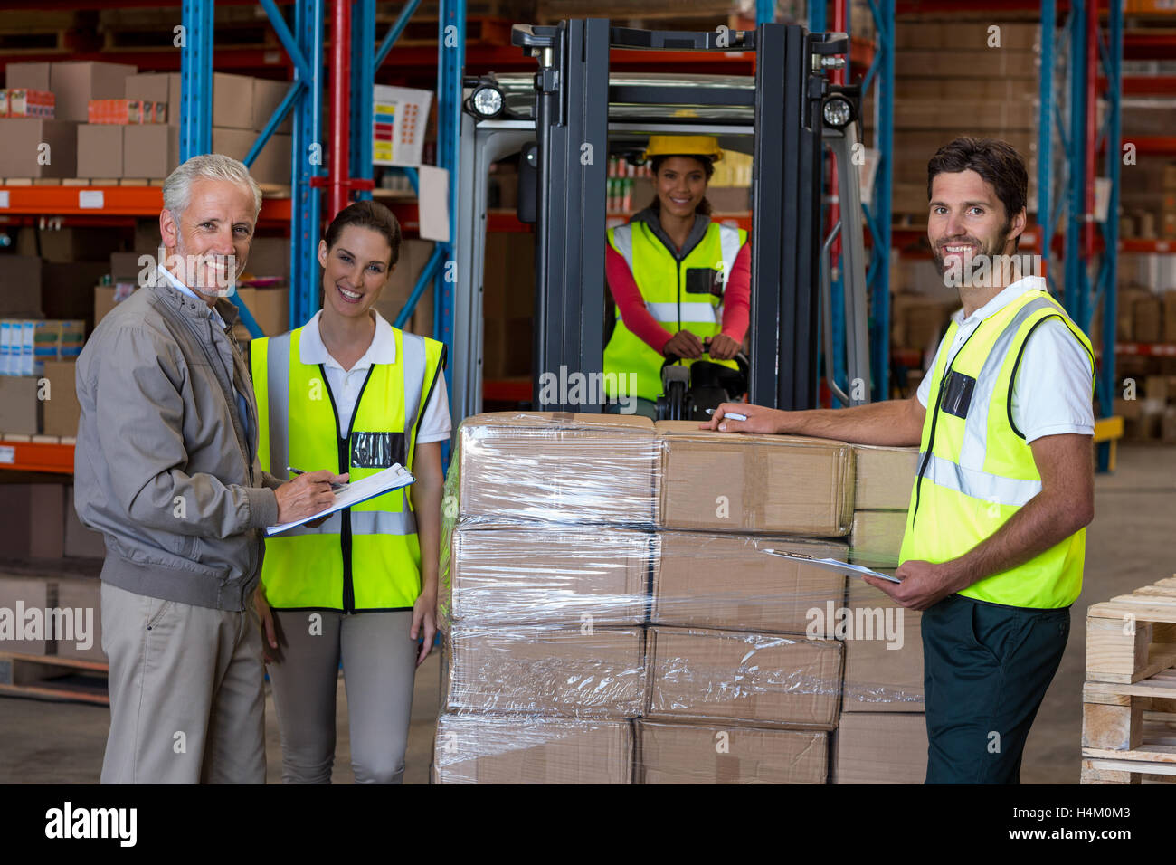 Warehouse manager and workers preparing a shipment Stock Photo