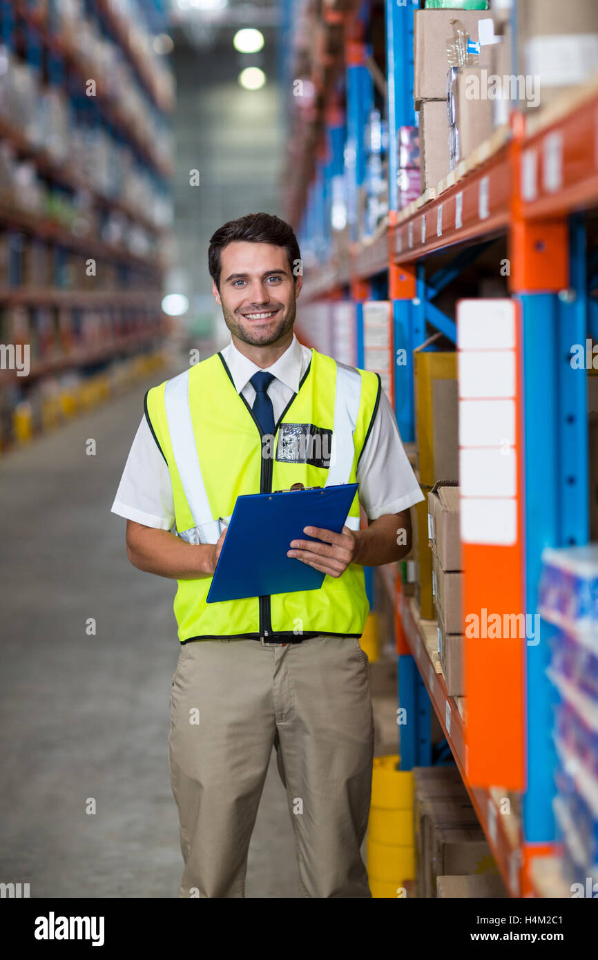 Warehouse manager holding clipboard Stock Photo