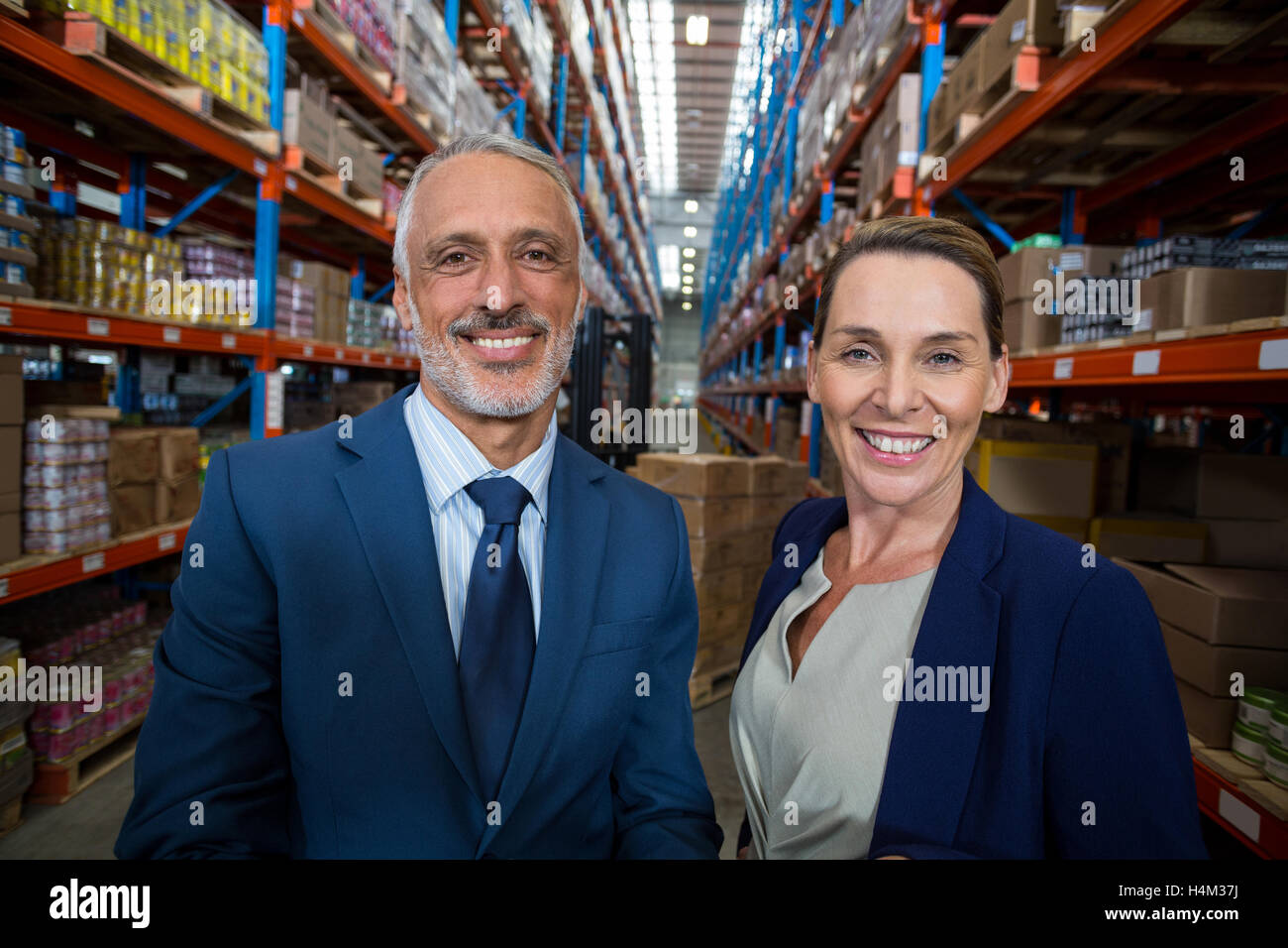 Portrait of warehouse manager and client smiling Stock Photo