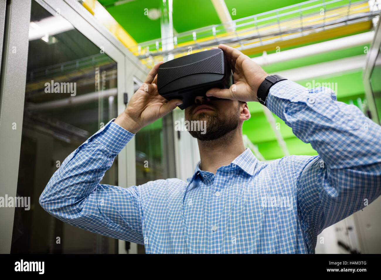Technician using virtual reality headset Stock Photo