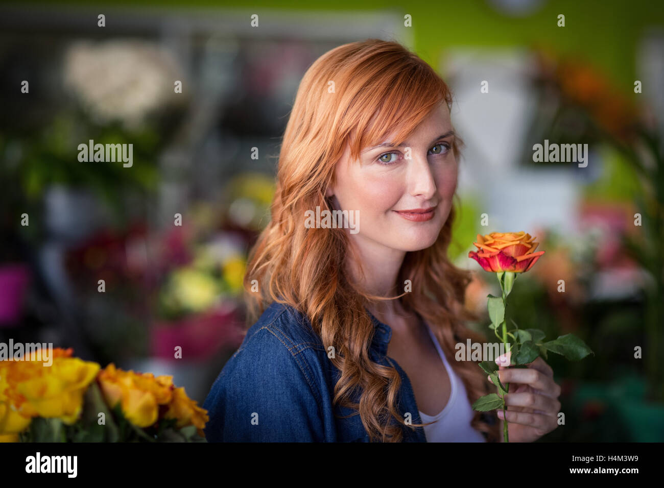 Female florist holding a rose flower Stock Photo Alamy