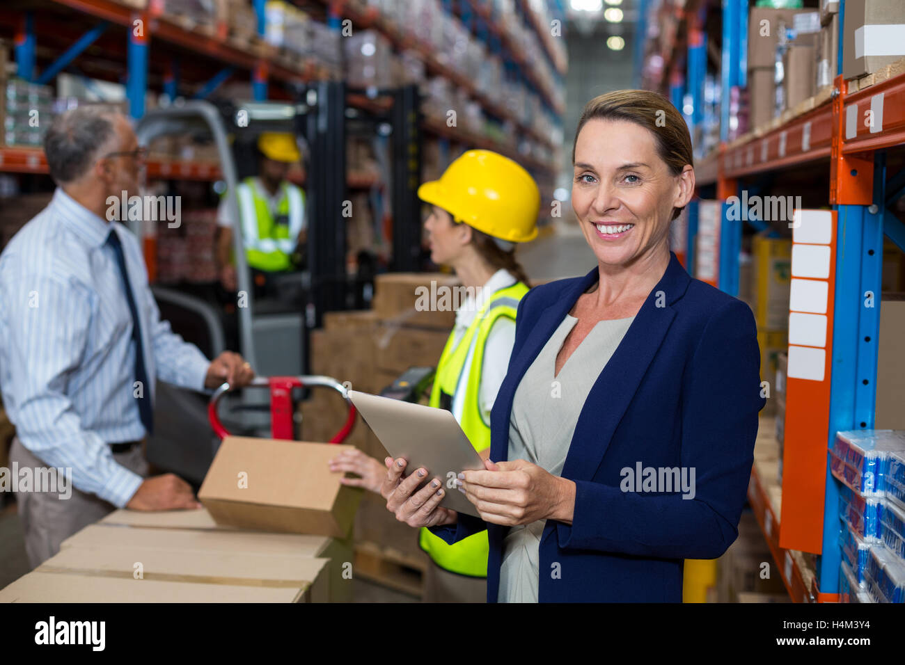 Warehouse manager holding digital tablet Stock Photo