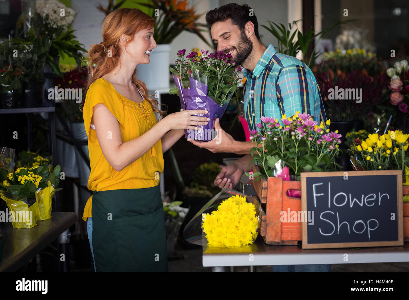 Female florist giving bouquet of flower to man Stock Photo Alamy