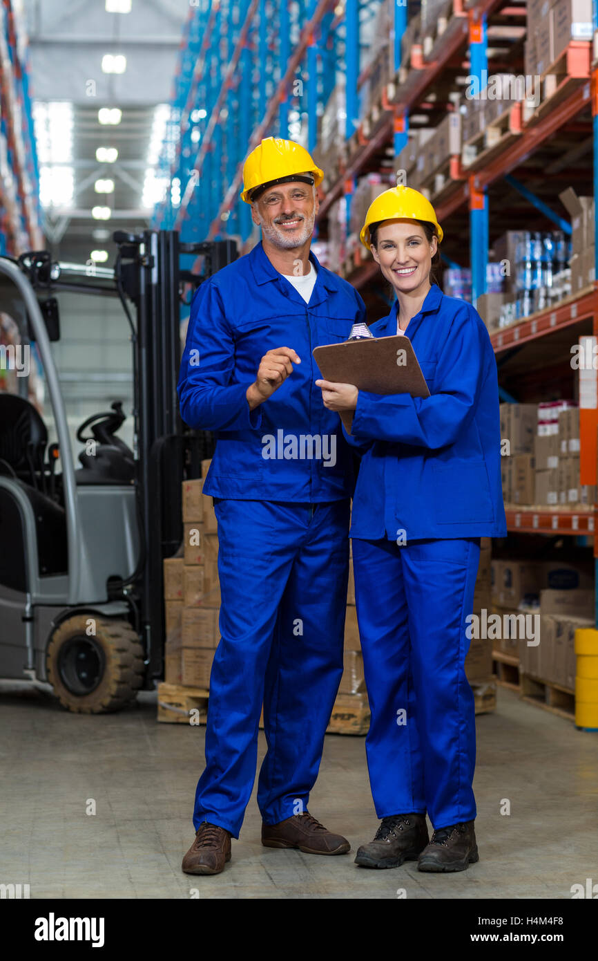 Warehouse workers standing together in warehouse Stock Photo
