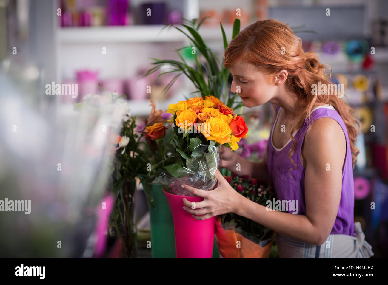 Female florist smelling flower bouquet Stock Photo Alamy