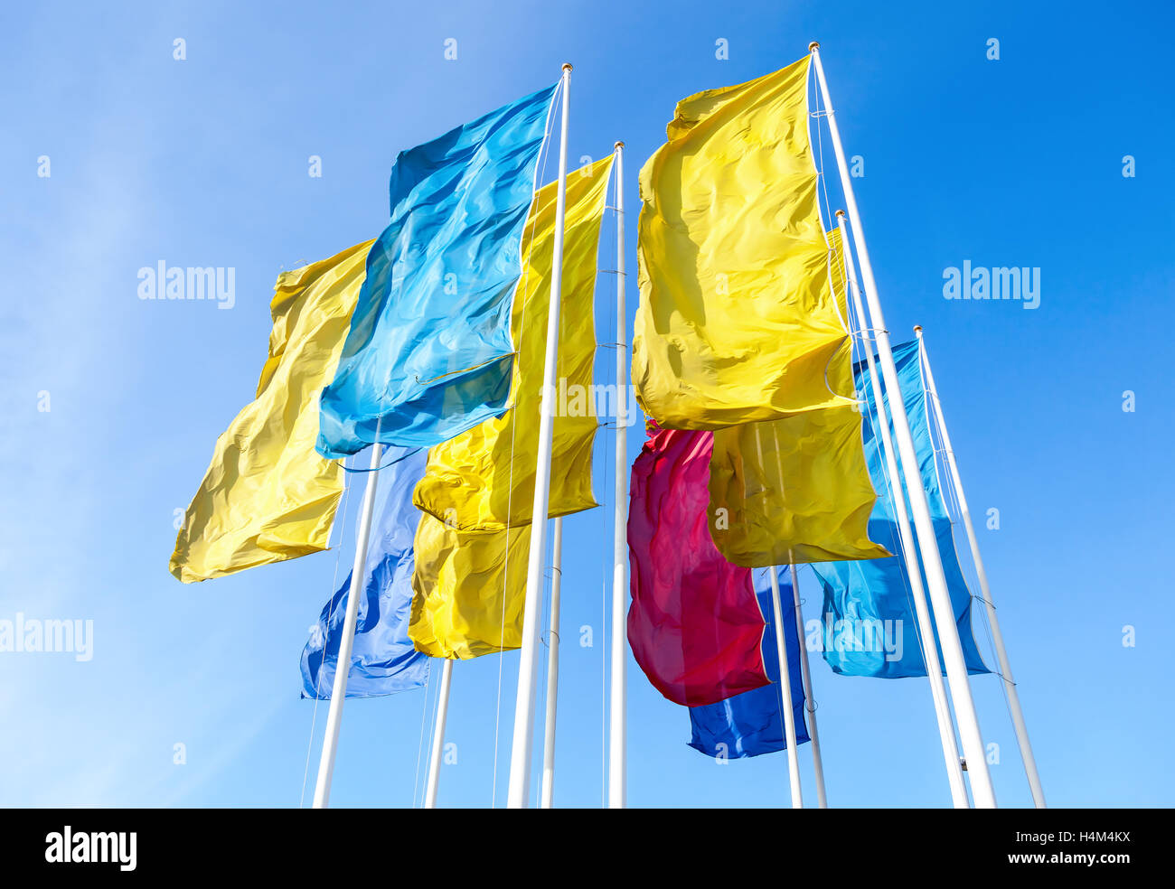 Colorful flags waving on the blue sky background Stock Photo - Alamy