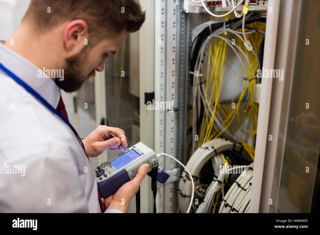 Technician using digital cable analyzer Stock Photo