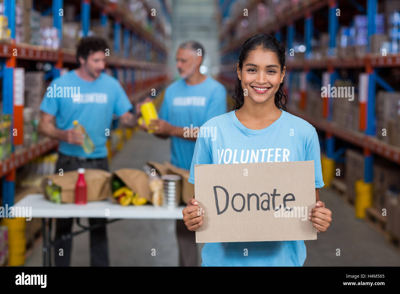 Portrait of happy volunteer holding sign boards with message Stock Photo