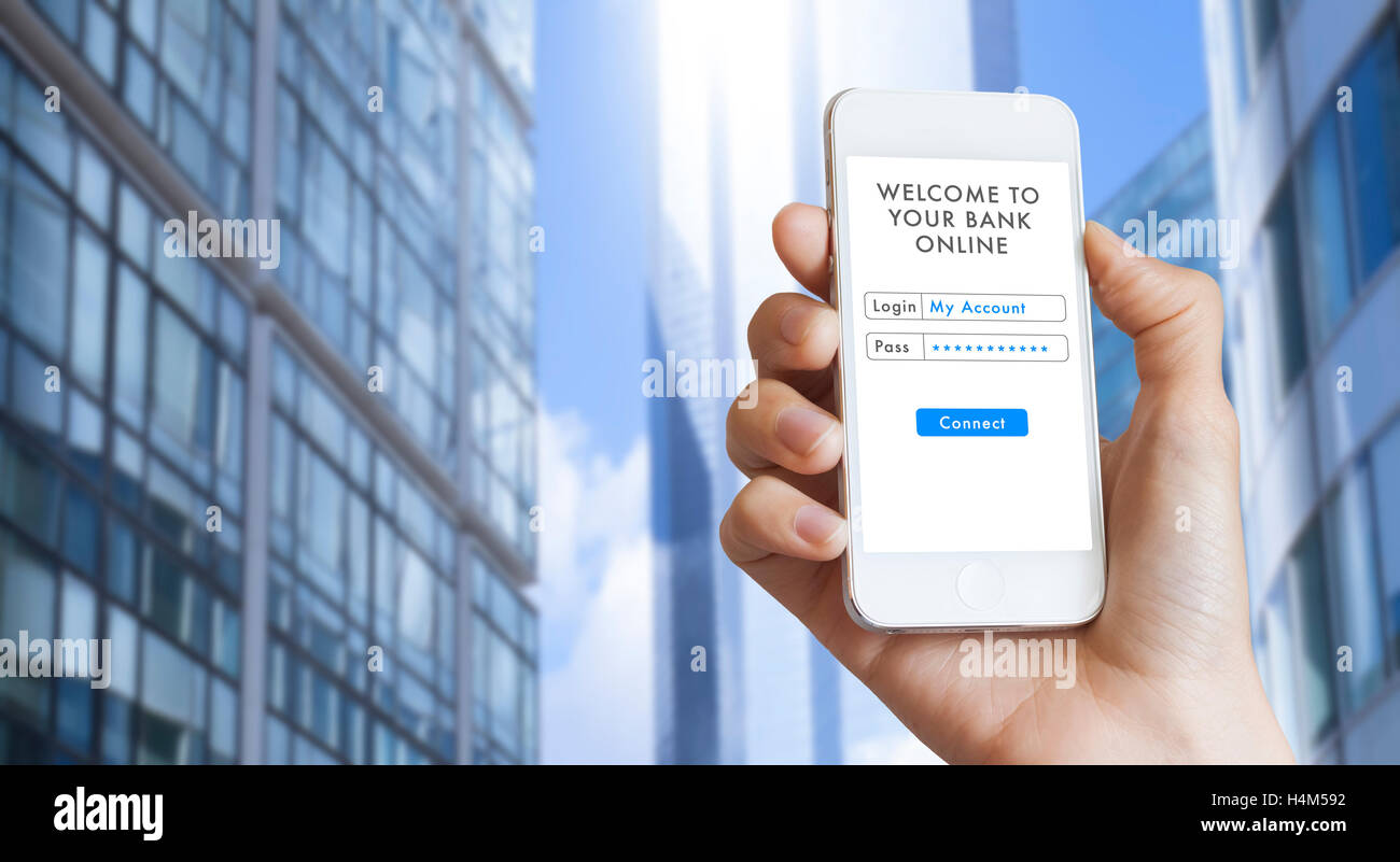 Online banking with a smartphone, woman hand holding a mobile phone in business district Stock Photo