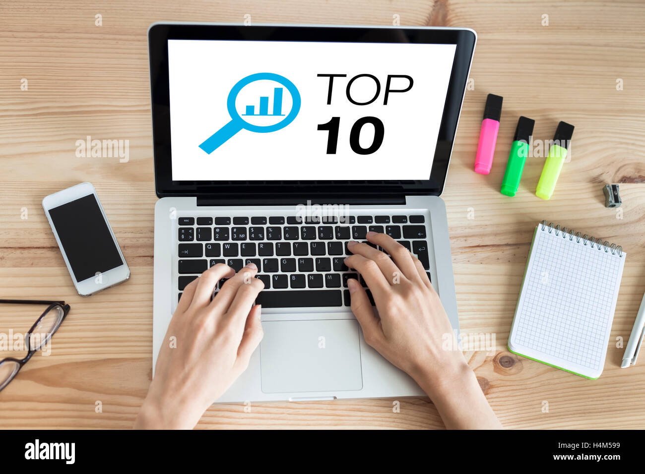 Top 10 list website on the screen of laptop computer with hands typing on keyboard Stock Photo