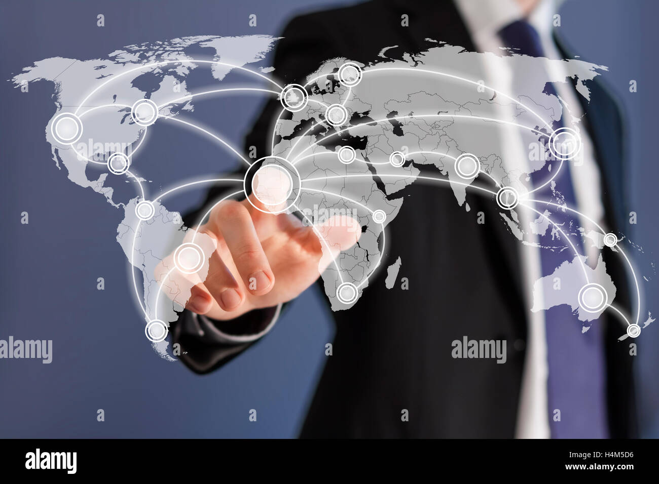 Social networks are worldwide as shown by a businessman on a world map touch screen Stock Photo