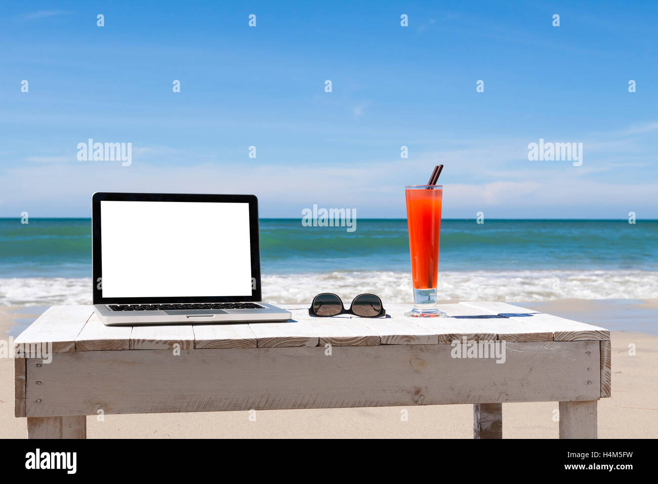 Working on the beach, white blank screen for copy-space Stock Photo