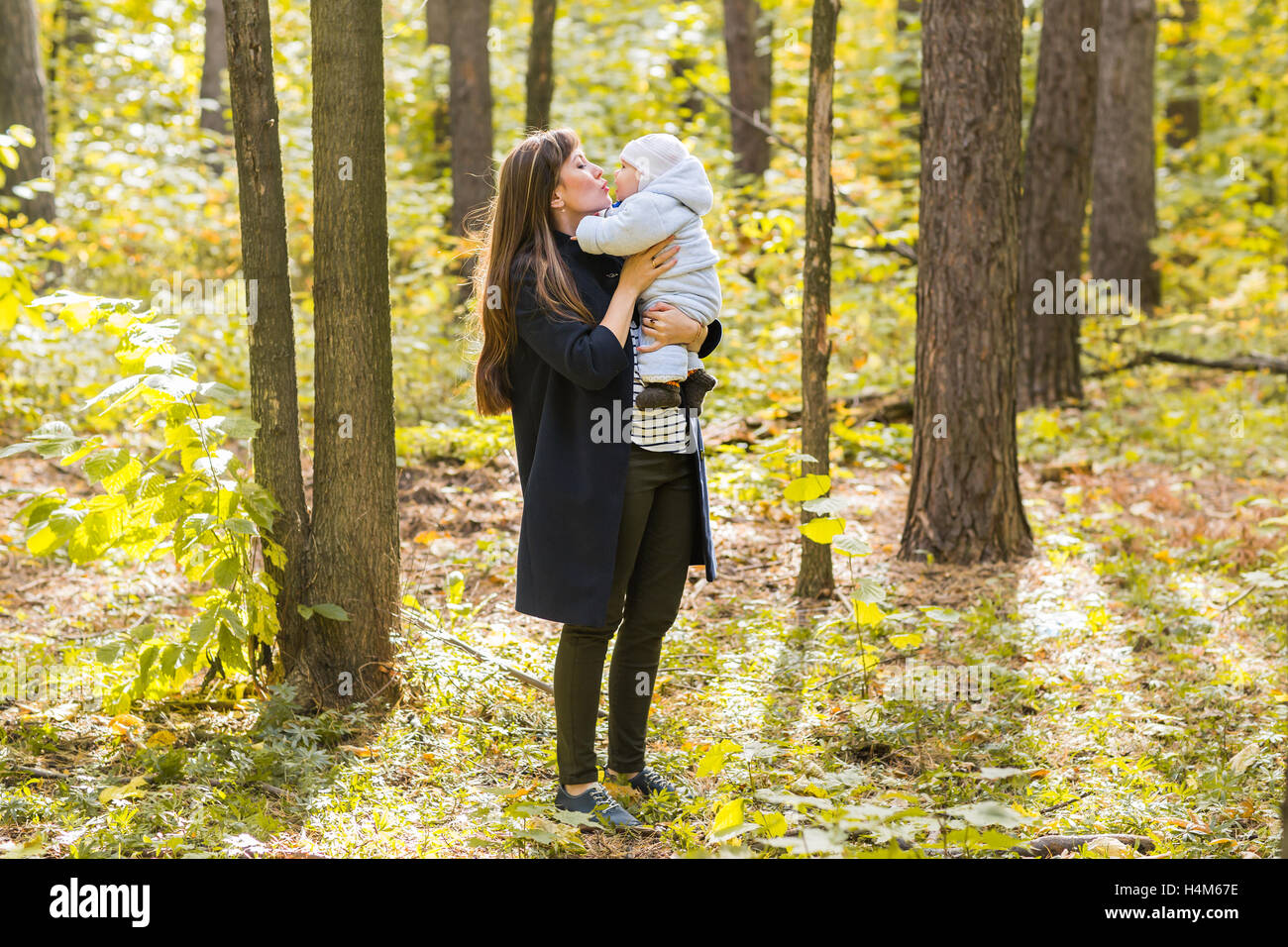 Young mother and her toddler girl have fun in autumn Stock Photo - Alamy